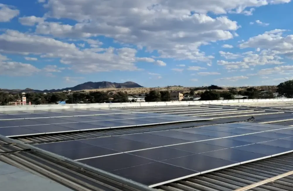 Commercial rooftop solar installation connected to the electricity grid in Namibia under partly cloudy daytime conditions