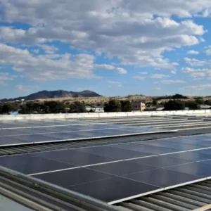 Commercial rooftop solar installation connected to the electricity grid in Namibia under partly cloudy daytime conditions